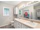 Bathroom featuring a double sink vanity, a large mirror, decorative tiling, and a shower/tub combo with unique curtain at 4125 89Th E St, Palmetto, FL 34221
