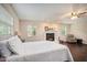 Bright bedroom featuring a cozy fireplace, dark wood floors, and a comfortable seating area with lots of natural light at 4125 89Th E St, Palmetto, FL 34221