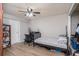 Neutral bedroom featuring a desk, ceiling fan, and light wood-look flooring offering both functionality and style at 4125 89Th E St, Palmetto, FL 34221