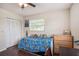 Bedroom featuring a window, closet, ceiling fan, and darker wood-look flooring to complete the space at 4125 89Th E St, Palmetto, FL 34221