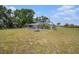 Spacious backyard featuring a blue two-story home, picnic table, and solar panels for energy efficiency at 4125 89Th E St, Palmetto, FL 34221