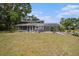 Blue two-story home with a screened porch and a spacious yard, perfect for outdoor entertaining at 4125 89Th E St, Palmetto, FL 34221
