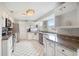 Bright kitchen with granite countertops, white cabinets, stainless steel appliances, and a convenient breakfast bar at 4125 89Th E St, Palmetto, FL 34221