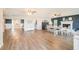 Open-concept living and dining room area featuring wood-look flooring, a cozy fireplace, and ample natural light at 4125 89Th E St, Palmetto, FL 34221