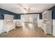 Stylish living room with decorative wainscoting, neutral wall paint, and beautiful wood-look flooring at 4125 89Th E St, Palmetto, FL 34221