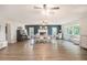 Spacious living room with fireplace, wood-look flooring, and bay window creating a bright and welcoming atmosphere at 4125 89Th E St, Palmetto, FL 34221