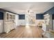 Bright and airy living room featuring neutral walls, wood-look flooring, and an open layout to the dining area at 4125 89Th E St, Palmetto, FL 34221