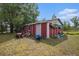 Red shed with equipment, offering extra storage space and functionality on the property at 4125 89Th E St, Palmetto, FL 34221
