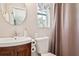 Bathroom includes a wooden vanity and sink, toilet, and shower with curtain at 4417 W Fair Oaks Ave, Tampa, FL 33611