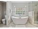Bright bathroom with a modern soaking tub and tiled shower at 4417 W Fair Oaks Ave, Tampa, FL 33611
