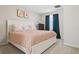 Bedroom showcasing a plush bed, side table, and window with dark blue curtains at 4417 W Fair Oaks Ave, Tampa, FL 33611