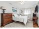 This bedroom features a wooden dresser, bed, and light colored walls at 4417 W Fair Oaks Ave, Tampa, FL 33611