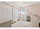 Bedroom with pink walls, white closets, and a window with sheer curtains at 4417 W Fair Oaks Ave, Tampa, FL 33611