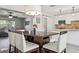Dining area adjacent to an open kitchen, featuring modern decor and ample seating at 4417 W Fair Oaks Ave, Tampa, FL 33611
