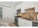 Well-equipped kitchen with granite countertops, stainless steel appliances, and custom cabinetry at 4417 W Fair Oaks Ave, Tampa, FL 33611