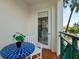 Cozy balcony with a mosaic table and a view of lush greenery at 4750 Dolphin Cay S Ln # 209, St Petersburg, FL 33711