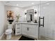 Updated bathroom featuring modern fixtures, a walk-in shower, vanity with storage, and contemporary design at 4750 Dolphin Cay S Ln # 209, St Petersburg, FL 33711