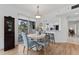 Cozy dining area featuring a round table, stylish chairs, and a view of the balcony at 4750 Dolphin Cay S Ln # 209, St Petersburg, FL 33711