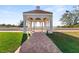 Charming outdoor gazebo with brick path and tiled roof offering stunning views of the ocean and beach at 4750 Dolphin Cay S Ln # 209, St Petersburg, FL 33711