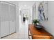 Bright hallway with a wooden console table, decorative bowl, and stylish artwork at 4750 Dolphin Cay S Ln # 209, St Petersburg, FL 33711
