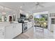 Bright, modern kitchen with stainless steel appliances, white cabinetry, and a view to the outside at 4750 Dolphin Cay S Ln # 209, St Petersburg, FL 33711