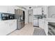 Modern kitchen with white cabinets, stainless steel appliances, and tile flooring at 4750 Dolphin Cay S Ln # 209, St Petersburg, FL 33711