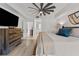 Spacious main bedroom featuring a ceiling fan, wood-look floors, and ensuite bath at 4750 Dolphin Cay S Ln # 209, St Petersburg, FL 33711