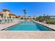 Community pool area with inviting pool, lounge chairs, and pergola at 4750 Dolphin Cay S Ln # 209, St Petersburg, FL 33711