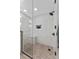 Modern walk-in shower featuring a glass enclosure, sleek tile, and convenient built-in shelving at 4750 Dolphin Cay S Ln # 209, St Petersburg, FL 33711