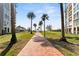 Scenic pathway with palm trees leading to the beach and amenities in the community at 4750 Dolphin Cay S Ln # 209, St Petersburg, FL 33711