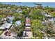Aerial view displaying home's proximity to the water, surrounding trees, and neighborhood at 515 Orange St, Palm Harbor, FL 34683