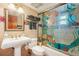 Unique bathroom features a pedestal sink, decorative shower screen, and tile accents at 515 Orange St, Palm Harbor, FL 34683