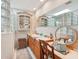 Elegant bathroom featuring double sinks, vanity area, unique glass block windows, and ample lighting at 515 Orange St, Palm Harbor, FL 34683