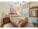 Comfortable bedroom with wooden furnishings, vibrant patchwork quilt, and stylish decor at 515 Orange St, Palm Harbor, FL 34683