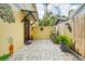 Charming courtyard with brick pavers and a decorative exterior wall with a covered entryway at 515 Orange St, Palm Harbor, FL 34683