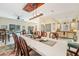 Spacious dining room with view of kitchen, pool, stylish decor and seating at 515 Orange St, Palm Harbor, FL 34683