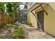Charming walkway leading to a cozy home with a screened pool in the background at 515 Orange St, Palm Harbor, FL 34683