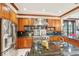 Gourmet kitchen with granite countertops, stainless steel appliances and custom wood cabinetry at 515 Orange St, Palm Harbor, FL 34683