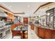 Open kitchen layout with stainless steel appliances, granite counters and adjacent living space at 515 Orange St, Palm Harbor, FL 34683