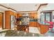 Well-equipped kitchen featuring a wine rack, granite countertops, stainless steel appliances, and ample storage at 515 Orange St, Palm Harbor, FL 34683
