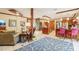 Spacious living room with tile flooring, a spiral staircase, kitchen, and custom wood trim at 515 Orange St, Palm Harbor, FL 34683