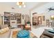 Inviting living room with large bookshelves, seating and view to dining room at 515 Orange St, Palm Harbor, FL 34683