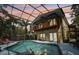 Stunning screened-in pool with attached spa and views of the home's balcony at 515 Orange St, Palm Harbor, FL 34683