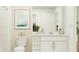 Well-lit bathroom with a modern vanity, toilet, and tiled shower at 5618 Red Kite Dr, Wimauma, FL 33598
