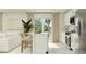 Modern kitchen with stainless steel appliances, white cabinetry, and a center island with seating at 5618 Red Kite Dr, Wimauma, FL 33598