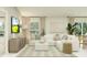 Comfortable living room features neutral tones, a plush sofa, and a large window at 5618 Red Kite Dr, Wimauma, FL 33598