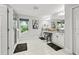 Bright bathroom with double sinks, framed mirror, elegant stool, and stylish finishes for a luxurious feel at 5809 Alabaster Stone Ln, Apollo Beach, FL 33572