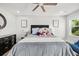 Bedroom featuring ceiling fan, wall art, and comfy bed with decorative pillows at 5809 Alabaster Stone Ln, Apollo Beach, FL 33572