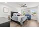 Comfortable bedroom with ceiling fan, natural light, and cozy seating area at 5809 Alabaster Stone Ln, Apollo Beach, FL 33572
