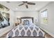 Comfortable bedroom with a ceiling fan, hardwood floors, and natural light from the window at 5809 Alabaster Stone Ln, Apollo Beach, FL 33572